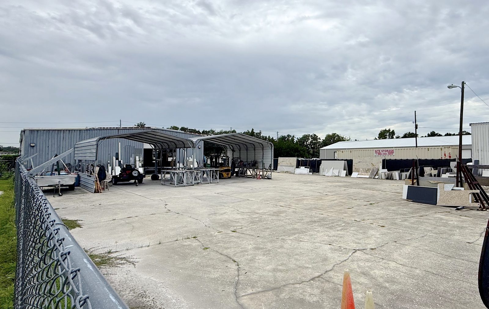 Covered fabrication bays opening onto the concrete work yard
